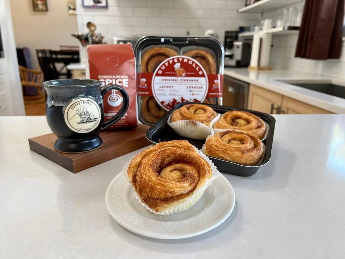A frozen bake-at-home Duffeyrolls pan next to a baked roll.